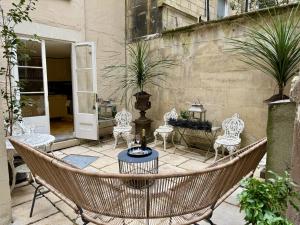 a patio with a hammock and chairs and a table at Abbey Mews in Bath