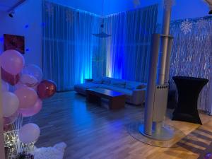 a living room with a couch and balloons at Kakumäe Raba Villa - Luxury Private Spa Villa in Tallinn in Tallinn