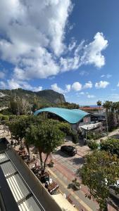 a building with a blue roof in a parking lot at Havana Apart Hotel in Alanya +98 photos