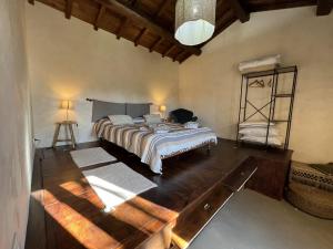 a bedroom with a large bed and a wooden floor at A casa di Lallo in Viterbo