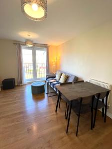 a living room with a couch and a table at Cosy two bedrooms flat suitable for a short trip in Portsmouth