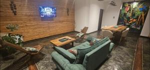 a living room with couches and tables and a wall at Casa amplia en Costanera in Posadas
