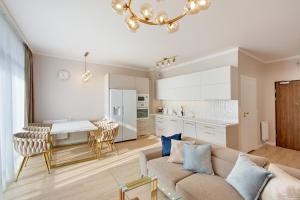 a living room and kitchen with a couch and a table at Aparts Care Beztroski Apartament Ku Morzu in Sianozety