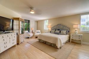 a large bedroom with a bed and a television at Pine Cove 204 in Sanibel +25 photos