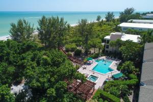 an aerial view of a resort with a swimming pool and the ocean at Pine Cove 204 in Sanibel