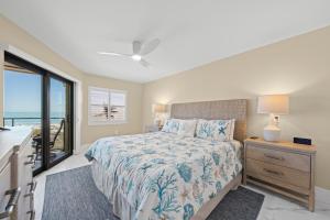 a bedroom with a bed with a view of the ocean at Pine Cove 403C in Sanibel +42 photos