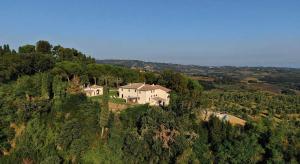 a large house on top of a hill at Agriturismo PANCOLINA in San Gimignano