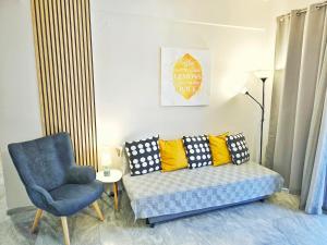 a living room with a couch and a chair at Gemareia Lodge in Lefkada