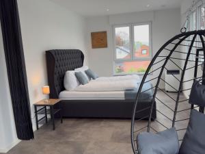 a room with a bed and a window at Luxus-Penthouse mit Terrasse & Klima in Siegburg