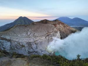 a view of a mountain with smoke coming out of it at Nio Homestay and Tour in Licin