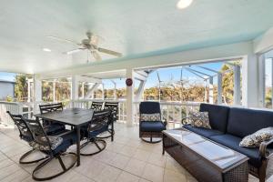 a living room with a couch and a table and chairs at Fantasea in Sanibel