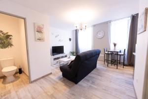 a living room with a couch and a table at Escapade dans le Verdon classé 3 étoiles in Riez +4 photos