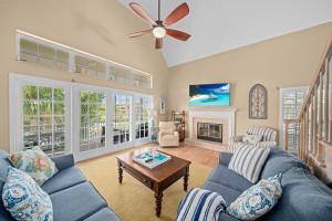 a living room with a blue couch and a table at Gone Coastal in Sanibel