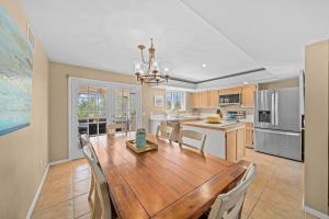 a kitchen and dining room with a wooden table and chairs at Gone Coastal in Sanibel
