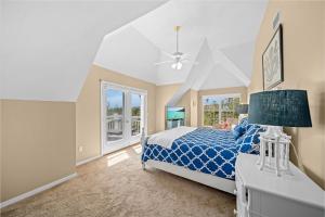 a bedroom with a blue bed and a window at Gone Coastal in Sanibel +55 photos