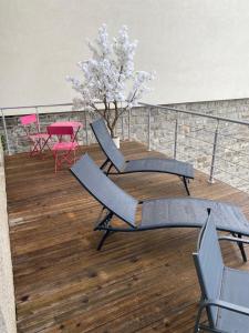a balcony with chairs and a table and a tree at Les Brises in Saint-Gingolph +5 photos