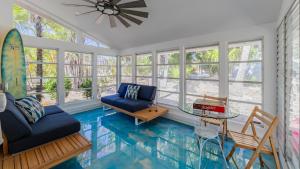 a living room with a floor that looks like a pool at Little Palm Cottage in Sanibel