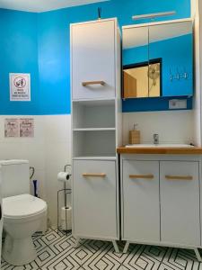 a bathroom with a white cabinet and a toilet at Apartamenty w centrum Wawel & Smok AC Progres in Toruń +32 photos