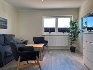 a living room with a couch and chairs and a table at 2013 FeWo Schauf Whg4 in Dahme