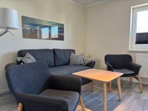 a living room with a couch and two chairs and a table at 2013 FeWo Schauf Whg4 in Dahme