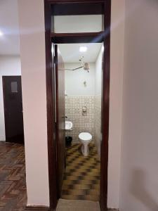 a bathroom with a toilet and a sink at Apartamento 111 - Suíte econômica com ar condicionado in Patos de Minas