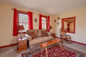 a living room with a couch and red curtains at Wyandot Woods - Firefly in Laurelville