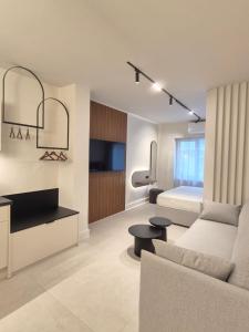 a living room with a couch and a bed at Shape Suites Athens in Athens
