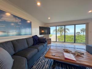 a living room with a couch and a table at Kings Crown 118 in Sanibel
