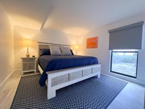 a bedroom with a bed with a blue comforter and a window at Kings Crown 118 in Sanibel +24 photos