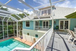 a house with a swimming pool and a deck at Glimmering Shells in Sanibel