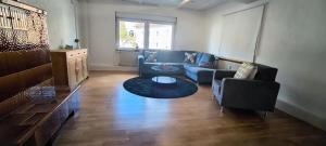 a living room with a couch and a table at 70 qm Ferienwohnung, in Groß-Bieberau