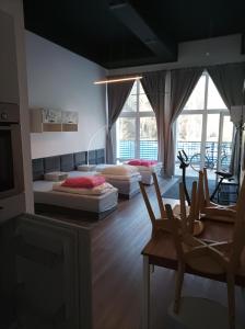 a living room with two beds and a table and chairs at Mirabella 1 in Kołobrzeg