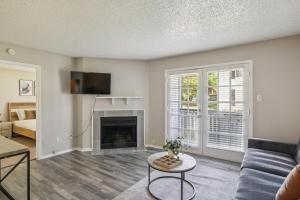 a living room with a couch and a fireplace at C Springs 614 I Spacious 1 Bed 1 Bath in Bedford