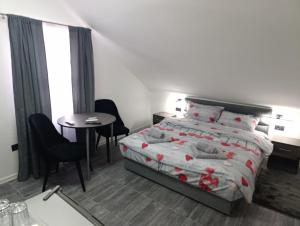 a bedroom with a bed and a table and chairs at Villa Vlasta in Soko Banja +72 photos