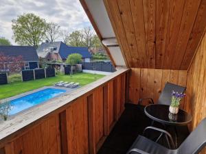 埃克斯鲁B&B Hartje Exloo的从带游泳池的房子后廊看到的景色