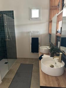 a bathroom with two sinks and a shower at Belle maison de caractère en Dordogne in La Bachellerie +23 photos