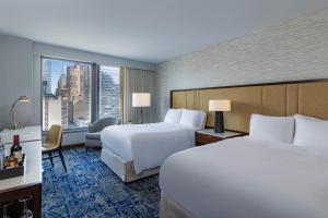 a hotel room with two beds and a large window at InterContinental New York Times Square by IHG in New York