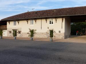 a large white building with a brown roof at Gites Domaine de la Rochere in Domsure