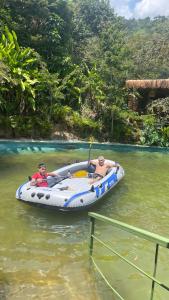two people in a speed boat on the water at ANCESTRAL GLAMPING in Barbosa