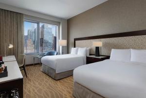 a hotel room with two beds and a large window at InterContinental New York Times Square by IHG in New York