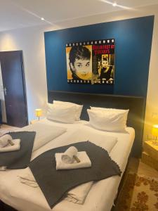 a bedroom with a large bed with towels on it at Altes Gasthaus Nagel in Niederdorla