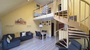 a living room with a couch and a staircase at Dandár Family Residence Free Parking in Budapest