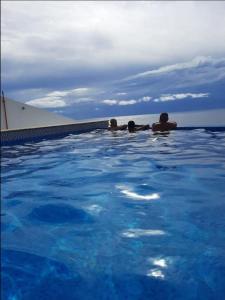 a group of people laying in a swimming pool at Blue ocean villa in Asilah