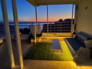 a balcony with a view of the ocean from a building at Seven Sky Penthouse in Sousse +29 photos