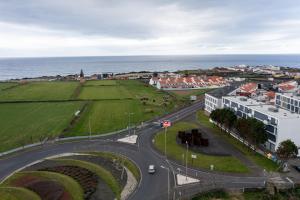 an aerial view of a road in a town next to the ocean at Areal de Santa Bárbara Sea View in Ribeira Grande