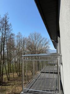 a cage in a building with trees in the background at Noclegi Laguna in Żywiec