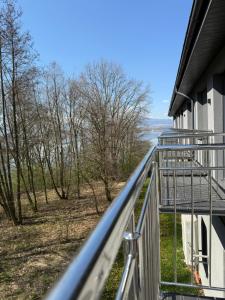 a balcony with a view of the water at Noclegi Laguna in Żywiec