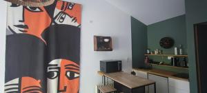 a kitchen with a table and a curtain in a room at Studio au cœur de Buis-les-Baronnies in Buis-les-Baronnies +5 photos