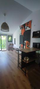 a room with a table and a large painting on the wall at Studio au cœur de Buis-les-Baronnies in Buis-les-Baronnies