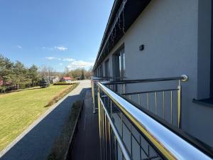 a balcony of a building with a walkway at Noclegi Laguna in Żywiec